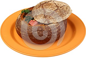 Borsch soup is poured in a dish as bread photo