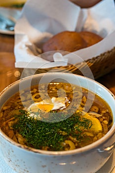 Borscht or borsht soup in a rustic bowl with sour cream and dill photo