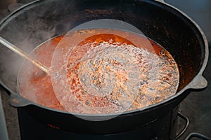 Borscht in the cauldron on the fire. Dinner in the countryside