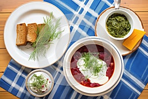 borscht meal for two, side of sour cream, pumpernickel bread, fresh herbs on top