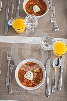 Borscht, Red Soup Made of Beetroot and Vegetables and Sour Cream Served with Garlic Rolls