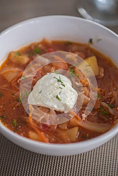 Borscht, Red Soup Made of Beetroot and Vegetables and Sour Cream Served with Garlic Rolls