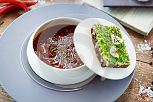 Borscht soup. Black Angus beef, beetroot, sour cream, toasted bread with smalec in a bowl. Delicious healthy food