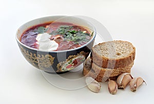 Borscht with sour cream and parsley, garlic bread