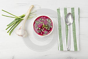 Borscht traditional beetroot soup, Ukrainian and Russian national cuisine. served in white bowl on wooden board. Top