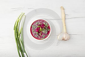 Borscht traditional beetroot soup, Ukrainian and Russian national cuisine. served in white bowl on wooden board. Top