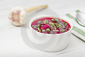 Borscht traditional beetroot soup, Ukrainian and Russian national cuisine. served in white bowl on wooden board. Top