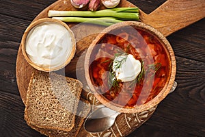 Borscht - traditional russian and ukrainian beetroot soup on wooden background.