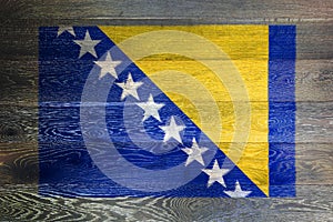 Bosnia Herzegovina flag on rustic old wood surface background