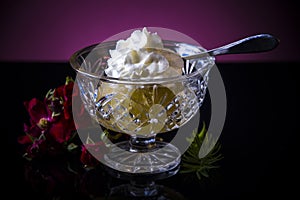 Bosnian sweet apple dessert in cup with cream foam. Dessert called Tufahija. photo