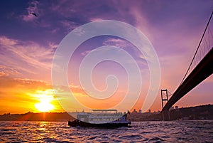 Bosphorus Bridge and excursion boat at sunset, Istanbul, Turkey