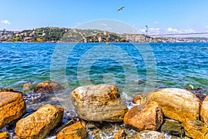 Bosphorus coast stones, the Sultan Fatih Mehmet Bridge and the Rumeli Hisari in the background