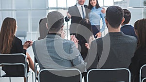 boss and business team congratulating the speaker at a business presentation.