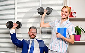 Boss businessman and office manager raise hand with dumbbells. Strong business team. Healthy habits in office. Man and