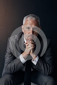 Boss, chair and serious portrait of lawyer, attorney or businessman with ceo on dark background in studio. Confidence