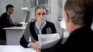 Boss checking female employee work results, probationary period at workplace