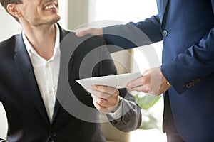 Boss congratulating employee with getting reward photo