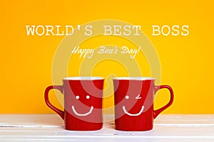Boss day greeting card with two red coffee mugs with a smiling f