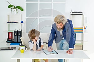 Boss and employee. Little boss and employee in the office. Old and yong business concept. Kids director business man in