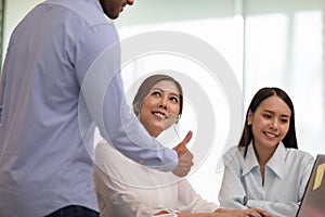 Boss encourages good job showing thumbs up to employee to get rewarded