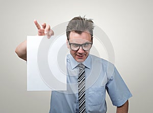 Boss in glasses holding the white paper