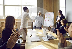 Boss handshake excited male employee greeting with promotion