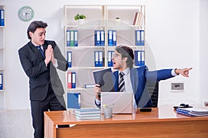 Boss and his male assistant working in the office