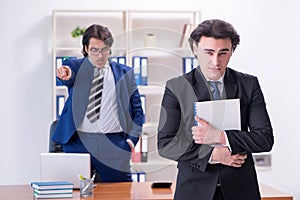 Boss and his male assistant working in the office