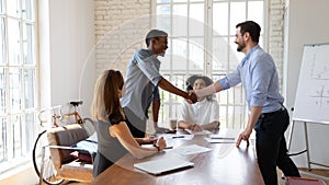 Boss making agreement with client or praising employee at office.