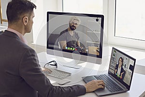 Boss making video calls to employees in home office.