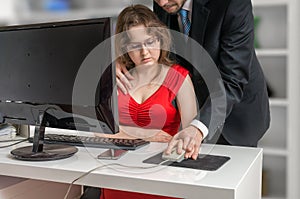 Boss or manager is seducting his secretary in office. Harassment concept. photo