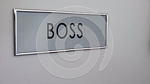 Boss office door, secretary hand knocking closeup, documents for signature