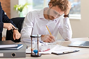 Boss reminding young man of duration in office