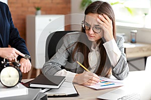 Boss reminding young woman of duration in office