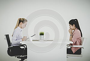 Scared businesswoman seriously talking in a job interview in an office