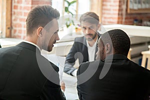 Boss scolding african-american employee because of unproductive