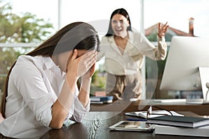 Boss screaming at employee in office. Toxic work photo