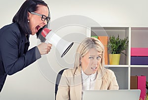 Boss shouting at employee on megaphone