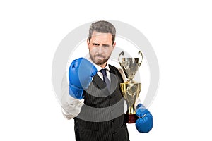 boss show victory and authority. businessman in boxing gloves with trophy.