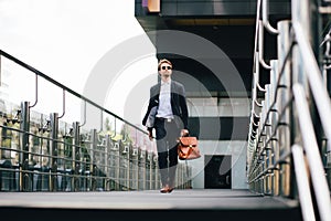 The Boss In A Suit And Sunglasses With A Briefcase In His Hand Goes To Work