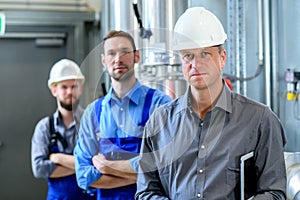 Boss with two worker in factory