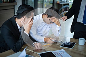 Boss is very angry and shouted to employee for reported sales decrease, employee is stressed and put hands on his head