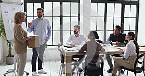 Boss welcome new employee older lady get acquainted with team