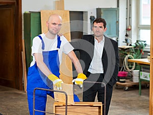 Boss and worker in a carpenter's workshop