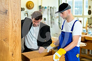 Boss and worker in a carpenter's workshop