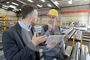 Boss and worker in conversation in factory