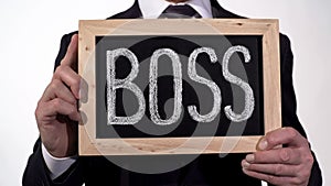 Boss written on blackboard in businessman hands, corporation top manager, leader