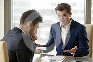 Boss yelling at employee for missing deadline, bad work results photo