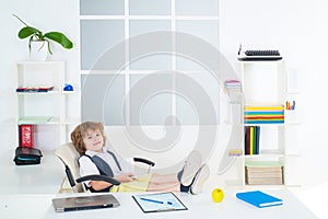 Bossy little kid boy businessman entrepreneur inside in office. Funny kids.