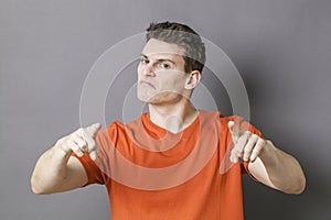 Bossy sporty man accusing someone with hands for blame